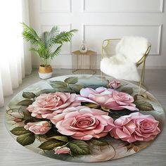 a round rug with pink roses on it in a room next to a chair and potted plant