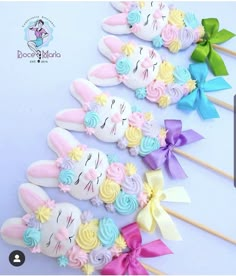 several colorful cake toppers with bunny ears and flowers on them