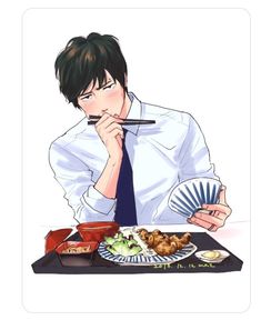 a man sitting at a table eating food with chopsticks in front of him