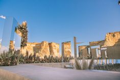 an outdoor ceremony setup with mirrors and flowers in the foreground, mountains in the background