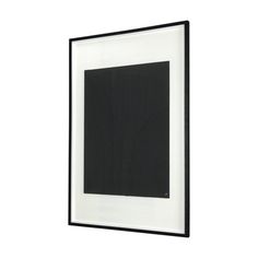 a black and white photo hanging on the wall above a framed art print with an abstract design