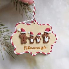 a christmas ornament with three gingerbread men