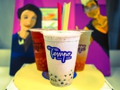 two frozen drinks sitting on top of a yellow plate