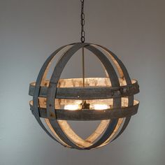 a wooden barrel chandelier hanging from a chain with two lights on it and one light turned on