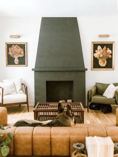 a dog laying on the floor in front of a fire place with two chairs and a couch