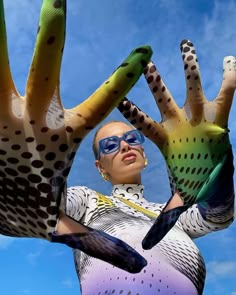 a woman with her hands in the shape of an animal's claws and wearing sunglasses