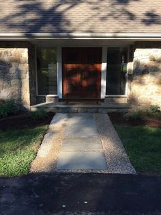 the front door of a house with stone steps leading up to it