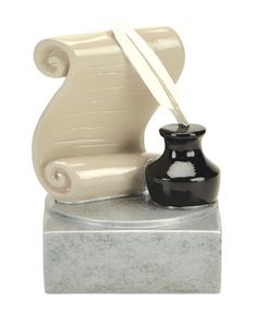 a black and white vase sitting on top of a marble block next to a scroll