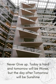 a tall building with lots of windows in the center and a quote on it that reads never give up today is hard and tomorrow will be worse