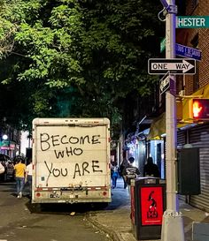 a sign that reads, become who you are on the back of a moving truck