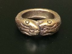 "This is a perfect and unique style magic ring made of brass metal by Lp Imm from Hua-khao temple. The power of the ring is to protect all dangers including ghost, evils and devils and the ring can bring good luck, fortune and wealth to the wearer. The ring showcases an elegant design with unique holy amulet. It is great to get this ring for your loved one or treat yourself for a classic timeless style. Amulet Name: Magic Nakabast Magic Ring Ring details: The exact benefit of the talisman and symbol means Naga lasso (Buang Nak Bas) ring Lucky amulet... Protection from danger.\" Those who own it know well the phrase, \"If you have something to eat... you won't go hungry. You eat like a snake eats its tail, and each one eats. The more you eat, the more they come together. When they hit each Ceremonial Symbolic Hand Cast Rings, Antique Bronze Hand Cast Ring, Symbolic Antique Finish Ring Jewelry, Symbolic Antique Finish Ring, Ceremonial Hand Cast Jewelry Ring, Ceremonial Antique Finish Jewelry Ring, Ceremonial Ring With Antique Finish, Ceremonial Antique Finish Ring, Collectible Antique Finish Jewelry Ring