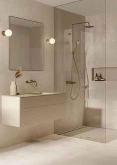 a bathroom with a sink, mirror and shower head in the wall next to it