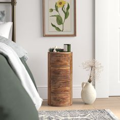 a bedroom with a bed, dresser and painting on the wall