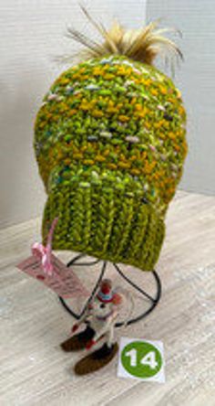 One-of-a-kind, ready-to-ship, handmade winter hat/beanie.  Bursting with color, this green, and mustard yellow multi-colored beanie features a 4" gold, faux fur, removable PomPom.  Made of fine Malabrigo Rasta wool yarn, this beanie must be hand washed and dried flat to preserve its softness and durability.  The hat measures 8" across and 9" tall allowing the wearer to pull it down over the ears or roll it up depending on the required warmth.  Knit from my own original design, The Poppy Hat pattern is available on Ravelry for the adventurous beginning knitter.  As with any handmade item, minor flaws and imperfections are inherent to its construction and adds a unique charm to the finished project. Green Winter Hat For Cold Weather, Green Knitted Winter Hat, Green Warm Winter Hat, Warm Green Hat For Outdoor, Multicolor Beanie For Fall, Warm Green Winter Bonnet, Warm Green Bonnet For Winter, Multicolor One Size Beanie For Fall, Multicolor Beanie For Fall, One Size Fits Most