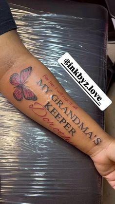 a person with a butterfly tattoo on their arm that says grandma's keeper and butterflies