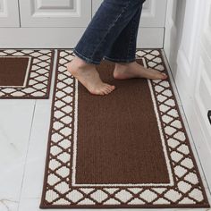 a pair of feet standing on a door mat