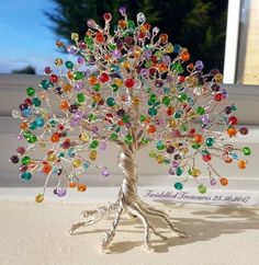 a tree with many different colored stones on it