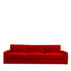 a red couch sitting in front of a white wall