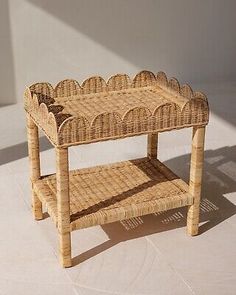 a small wicker table with two shelves