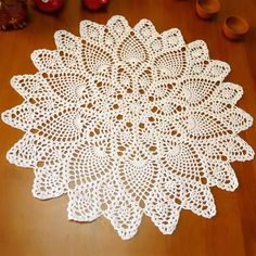 a white doily sitting on top of a wooden table