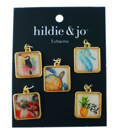 four square pendants with pictures of animals and seahorses on them in gold tone