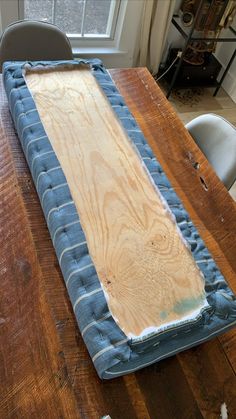 a wooden table topped with a blue and white mat