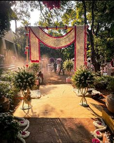 an outdoor ceremony with flowers and decorations