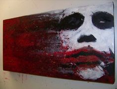 a painting on the wall of a man's face with red and white paint