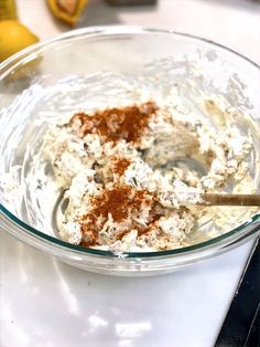 a glass bowl filled with food sitting on top of a counter