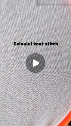 an orange and white object with the words colonial knot stitch on it's side