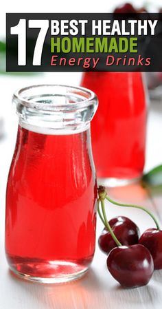 two jars filled with red liquid next to cherries