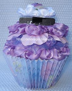 a cupcake decorated with purple and white flowers