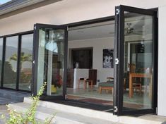 an open sliding glass door on the outside of a house