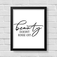 a framed black and white poster with the words beauty doesn't rinse off