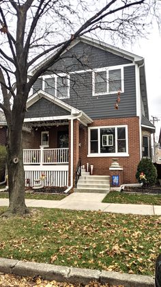 a house that is in the fall with leaves on the ground and trees around it