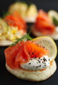 an open face sandwich with smoked salmon and cream cheese on it's buns