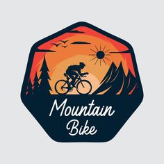 a mountain bike logo with the sun setting in the background and trees on the other side