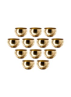 eight brass bowls are arranged in a pyramid