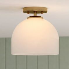 a white light hanging from the ceiling in a room