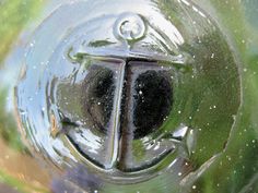 the top part of a glass vase with water on it