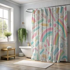 a bathroom with a rainbow shower curtain next to a bathtub and window sill