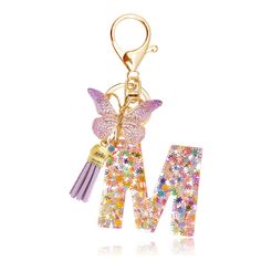 a keychain with a butterfly on it and the letter m in front of it