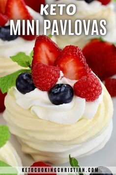 some cupcakes with white frosting and berries on top