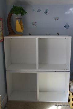 a white bookcase in a room with blue walls