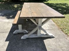 a wooden table sitting on top of a sidewalk