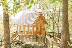 a small wooden cabin in the woods surrounded by trees