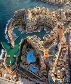 an aerial view of a city with boats in the water and lots of buildings around it