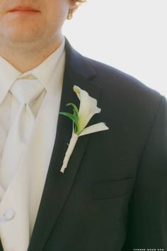 a man in a suit with a flower on his lapel