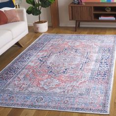 a living room with a couch and rug on the floor