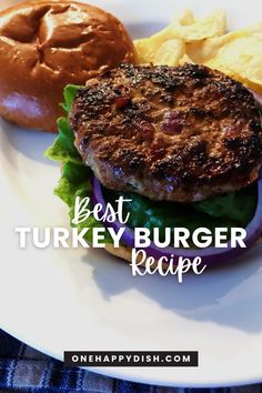 the best turkey burger recipe on a white plate with potato chips and a bagel